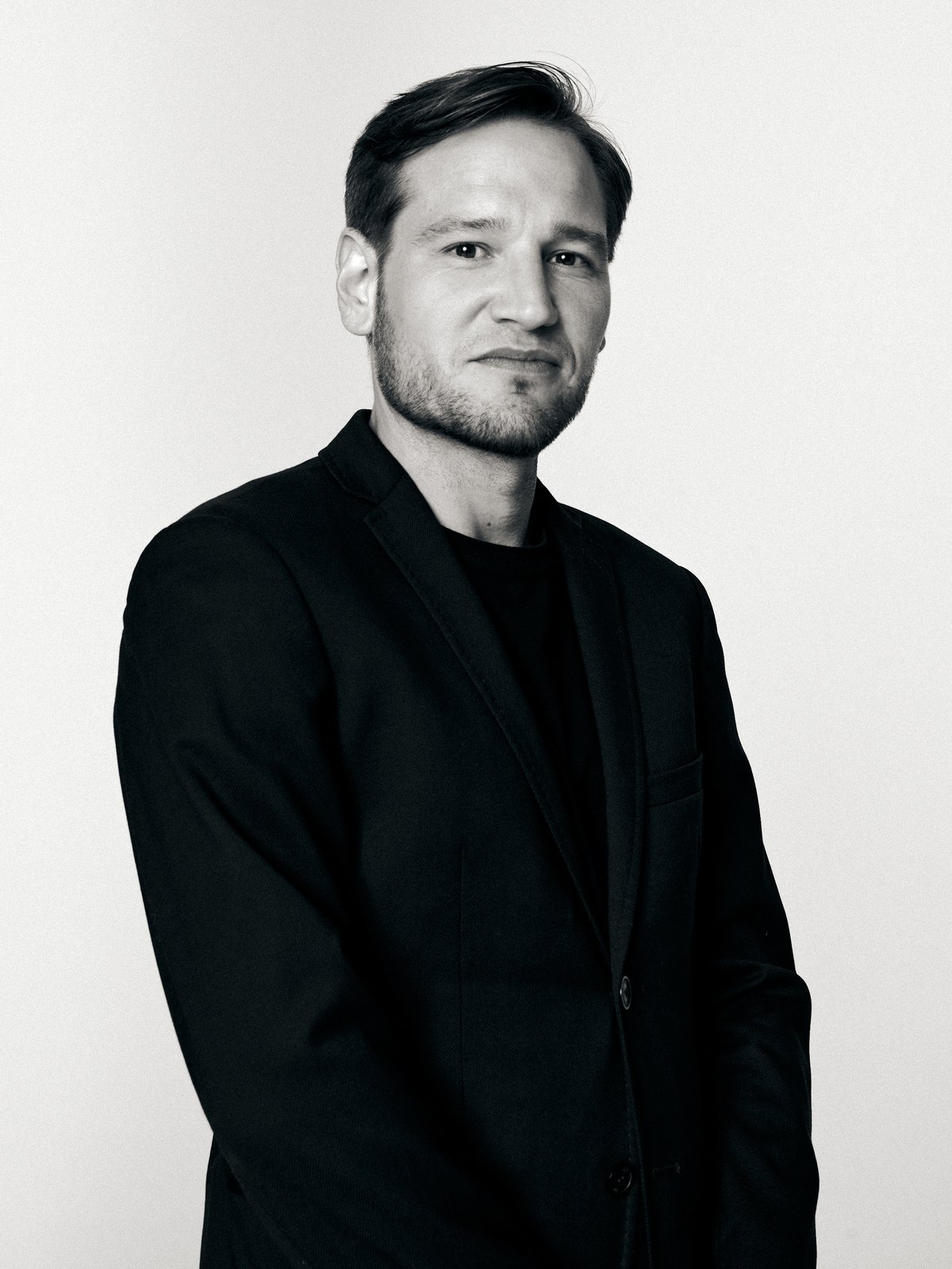 Black-and-white portrait of Prot Urban in a dark jacket
